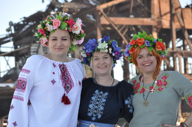 A group portrait with traditional embroidered clothing and flower crowns
